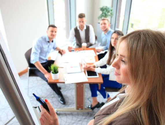 Therapist taking notes on a clipboard while listening to a patient during a counseling session, representing psychotherapy, mental health care, and emotional support