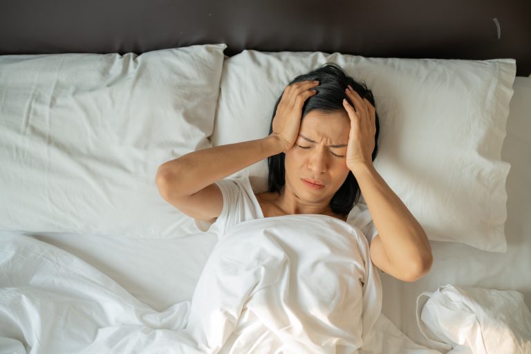 Woman experiencing emotional distress and anxiety related to Body Dysmorphic Disorder (BDD)
